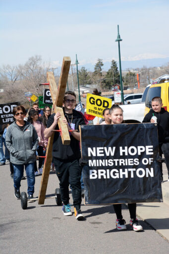 Brighton Residents Carry the Cross of Jesus Christ